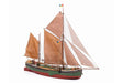 Model sailboat with brown sails on a white background
