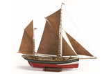 Model sailboat with brown sails and red hull on a white background