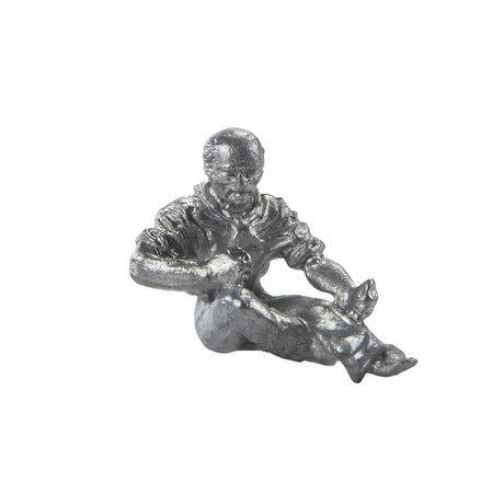 A small metallic figurine of a seated man holding a guitar, finished in a textured silver finish, isolated on a white background.
