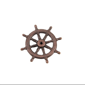 A single ship's wheel decorative piece or hardware charm in a distressed bronze-brown finish, isolated on a solid white background.