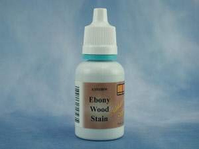 A small white plastic bottle of Ebony Wood Stain with a white cap and a brown label, set against a mottled blue background.