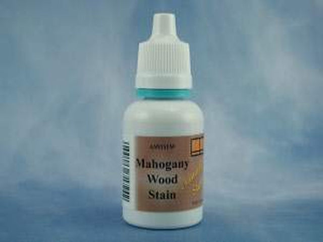 A small white plastic bottle of Mahogany Wood Stain with a white cap, featuring a brown label, set against a mottled blue background.